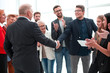 © ASDF - colleagues handshaking after meeting in office