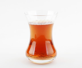 Poster - Closeup of fresh tea in a Turkish tea glass isolated on a white background