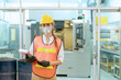 © godji10 - Portrait of female technician engineer control machines in the factory on a business day. Confident worker wearing particulate respirator mask with hard hat. Concept of Industrial manufacturing.