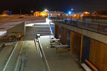 Wall Mural - Night view of the deserted city beach of Reykjavik in Iceland. Geothermal pool building.