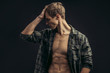 © alfa27 - Portrait of a beautiful young athletic man in checkered shirt with opened naked torso in the studio, black background. Caucasian man looking side