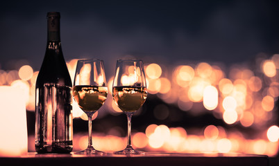 two glasses of wine champagne on city light background