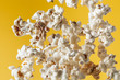 © alexanderon - Cheesy popcorn flying in front of the yellow background