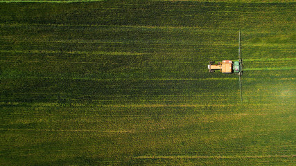 Poster - Aerial shot of a tractor cultivating a field