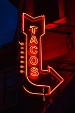 A Neon Sign Advertising Tacos Glows In The San Francisco Night