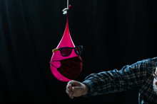 Closeup Shot Of Water Balloon About To Be Popped With Mask And Sunglasses - Concept Of New Normal