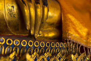 Wall Mural - Close up of gold buddha statue in the temple in Thailand.