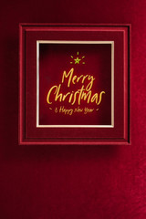 Aufkleber - Merry Christmas and happy new year glowing with star in picture frame on velvet red felt fabric wall.winter holiday background