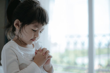 Wall Mural - Asian little girl hand praying for faith, spirituality and religion.