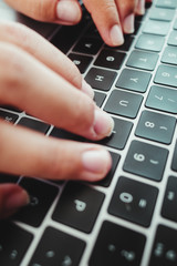 Canvas Print - Vertical shot of male hands using a laptop keyboard