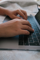 Canvas Print - Vertical shot of male hands using a laptop keyboard