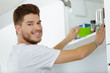 © auremar - young man getting items from the food cupboard