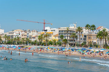 Sticker - SITGES, SPAIN - Jul 29, 2020: People in the beach in Sitges in summer 2020.