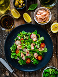 Fototapeta  - Salmon salad - roasted salmon and vegetables on wooden background
