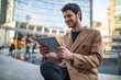 © Minerva Studio - Young man using his tablet outdoor