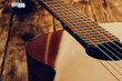 Wooden acoustic guitar body and fingerboard close up