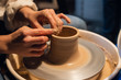 © Anna Kosolapova - beautiful hands of a young Potter's girl in the process of modeling a pot in the workshop.