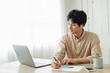 © One - One man working remotely and a cat.