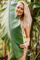 Sticker - Woman in swimsuit on tropical plants background