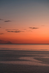 Sticker - Amazing shot of a beautiful seascape on an orange sunset background