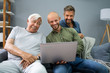 © Andrey Popov - Happy Three Generation Men Using Laptop