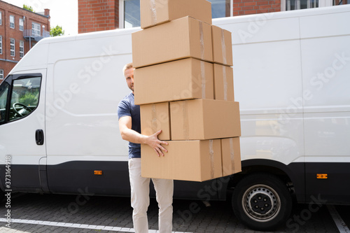 Movers Carrying Heavy Large Box Stack
