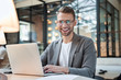 © Yakobchuk Olena - Excited worker sitting at the desk in coworking space