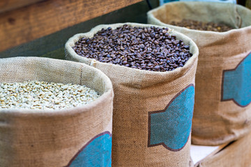Aufkleber - different kind of fresh Coffee beans in big burlap bags at market