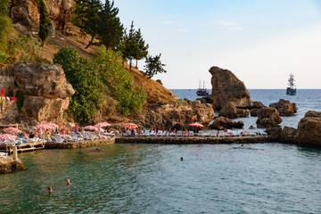 People swimming at the beach at old town port at Antalya in Turkey