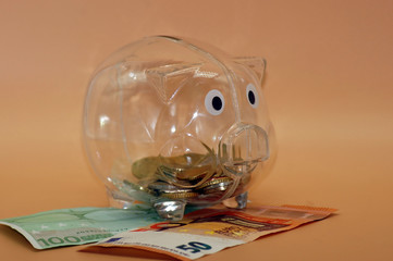 Wall Mural - Closeup shot of a piggy bank with Euro banknotes - financial savings concept