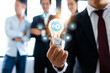 © khwanchai - Business man holding light bulb with connection line icon with teamwork background, brainstorming and creative innovation concept