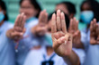© arrowsmith2 - Students girl showing three finger salute in school
