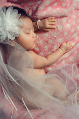 Wall Mural - close up newborn baby sleeping on a pink blanket.