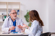 © Elnur - Old male doctor and his young female assistant in the clinic