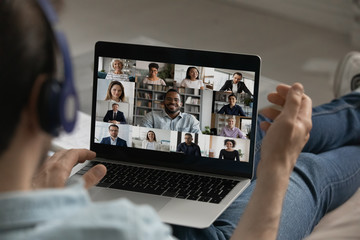 Wall Mural - back view close up of male employee have webcam group digital conference on laptop, engaged in team 