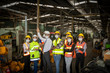 © Ron - Team of mechanic engineers with face mask standing together in front of a factory during COVID-19 outbreak. Group of technicians are very happy with business results after Coronavirus crisis