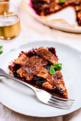 Wall Mural - Slice of Delicious Homemade Berries Honeysuckle Pie on beige linen tablecloth. Selective focus