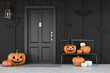 Black house door with carved pumpkins