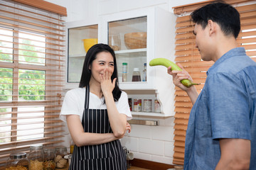 A young man with a eggplant that represents the male genitalia that is ready to fight. He has a lust for sex after helping his wife cook in the kitchen.  Sex toys