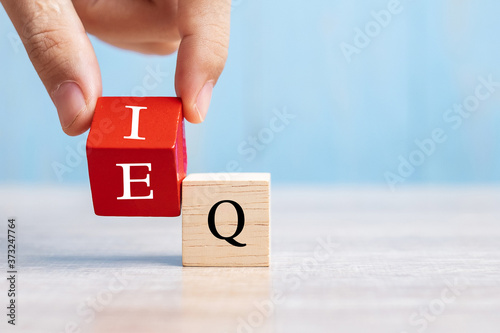 Fotomural Business man hand change wooden cube block from IQ to EQ, balance between intell