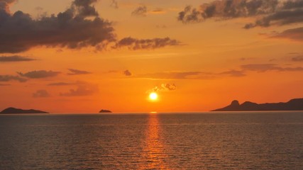 Wall Mural - Sunset time above the ocean, water surface in slow motion at sunset time