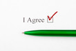 Text I Agree checkbox on white paper with green pen. Checklist concept.