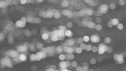Wall Mural - bokeh sun glare reflected in water surface. abstract ripples, sun glares, circles on waves water. ro