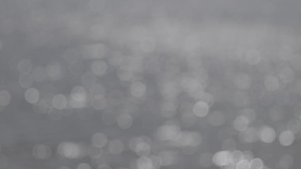 Wall Mural - bokeh sun glare reflected in water surface. abstract ripples, sun glares, circles on waves water. ro