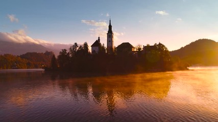 Wall Mural - Aerial sunset view of church of Assumption in Lake Bled, Slovenia. Video