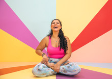 Young Woman In A Yoga Pose In A Colorful Room