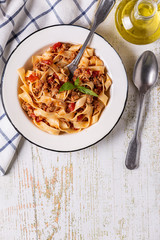 Wall Mural - Traditional italian pasta bolognese on a white plate on a wooden background