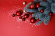© Larysa - Christmas background in red and green. Nobody. Decorative composition: Christmas tree, large, small balls of red and gold, artificial snow. Top view. Horizontal, Place for text. Happy New Year theme.