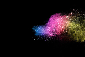 Wall Mural - explosion of colored powder isolated on black background.