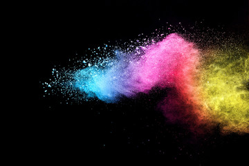 Wall Mural - explosion of colored powder isolated on black background.